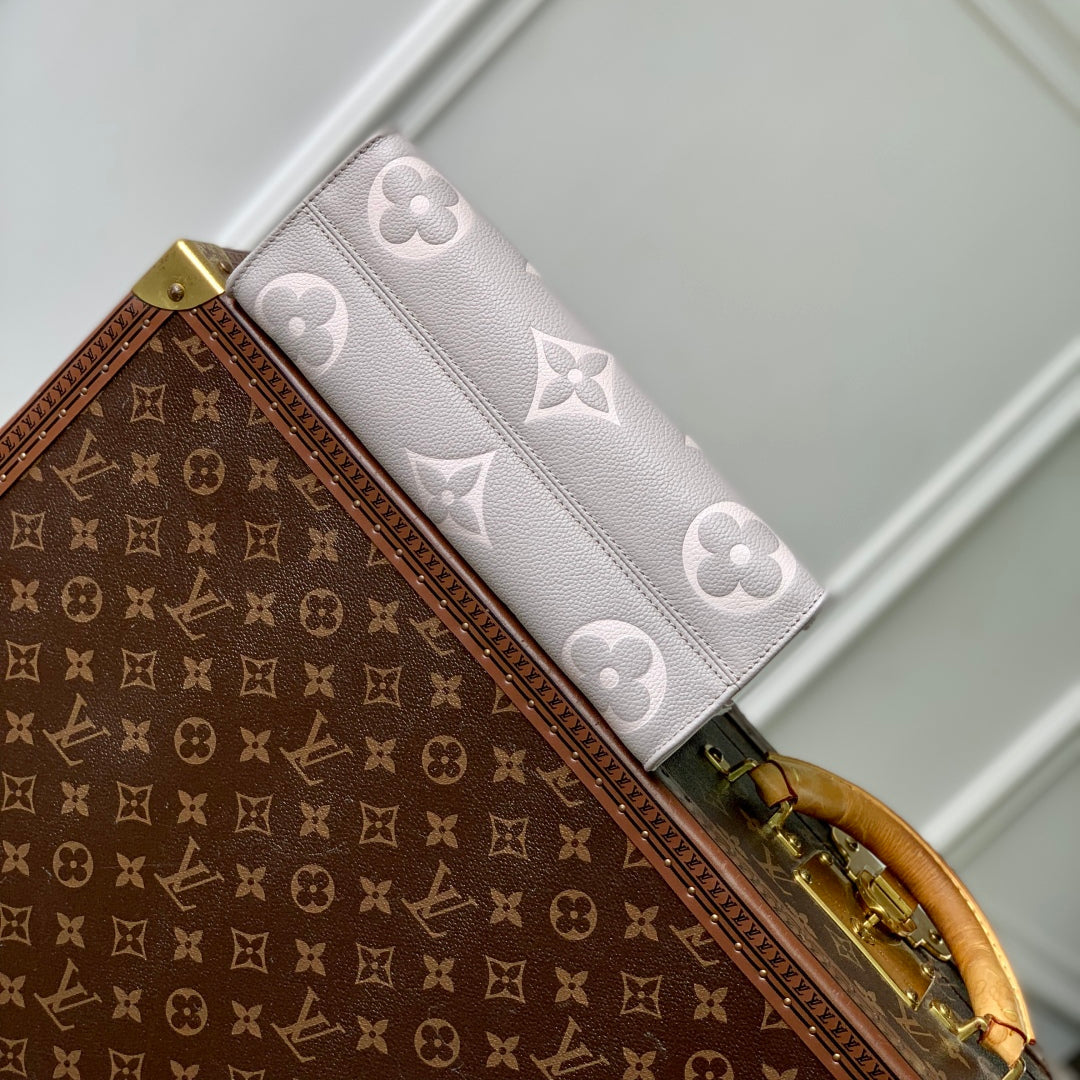 LOUIS VUITTON ONTHEGO EAST WEST BAG 25 IN BICOLOR MONOGRAM EMPREINTE LEATHER
