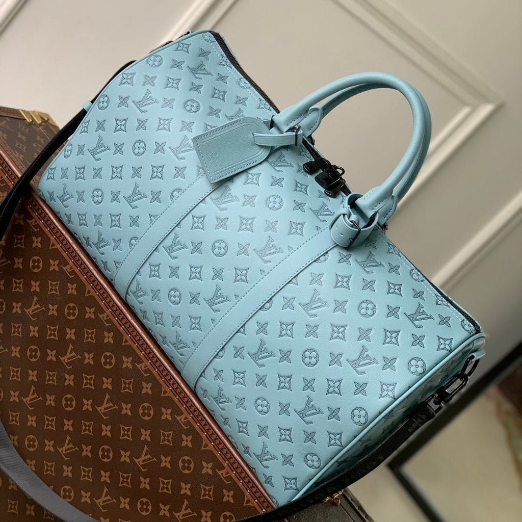 LOUIS VUITTON KEEPALL BANDOULIÈRE 50 IN SKY BLUE MONOGRAM SHADOW EMBOSSED CALFSKIN