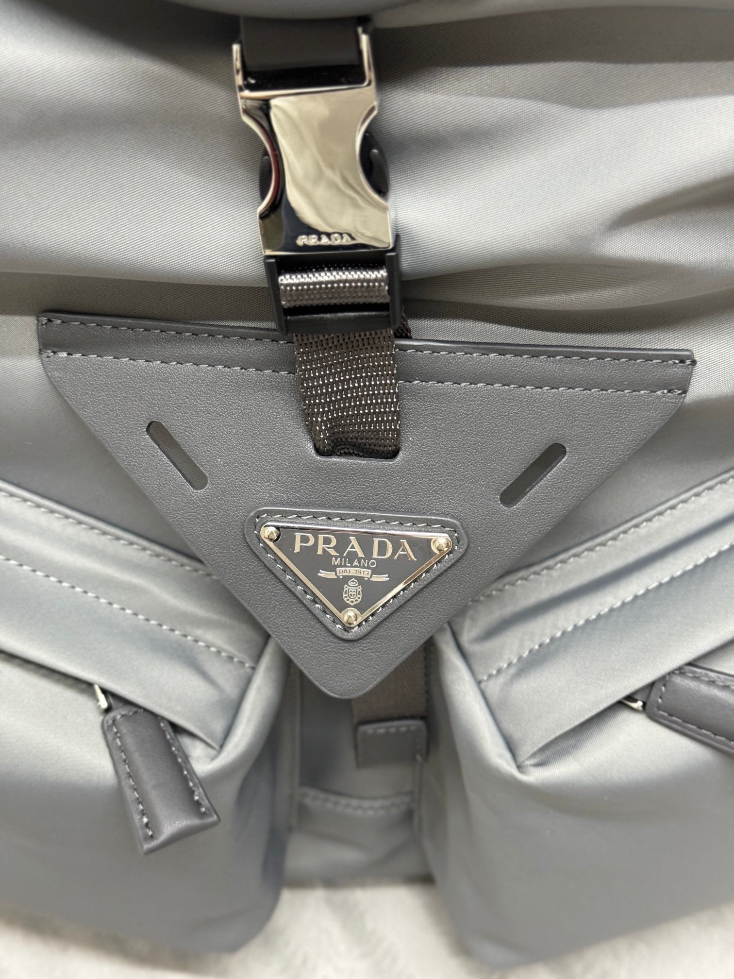 PRADA TRIANGLE LOGO BACKPACK 42 IN RHINO GRAY RE-NYLON